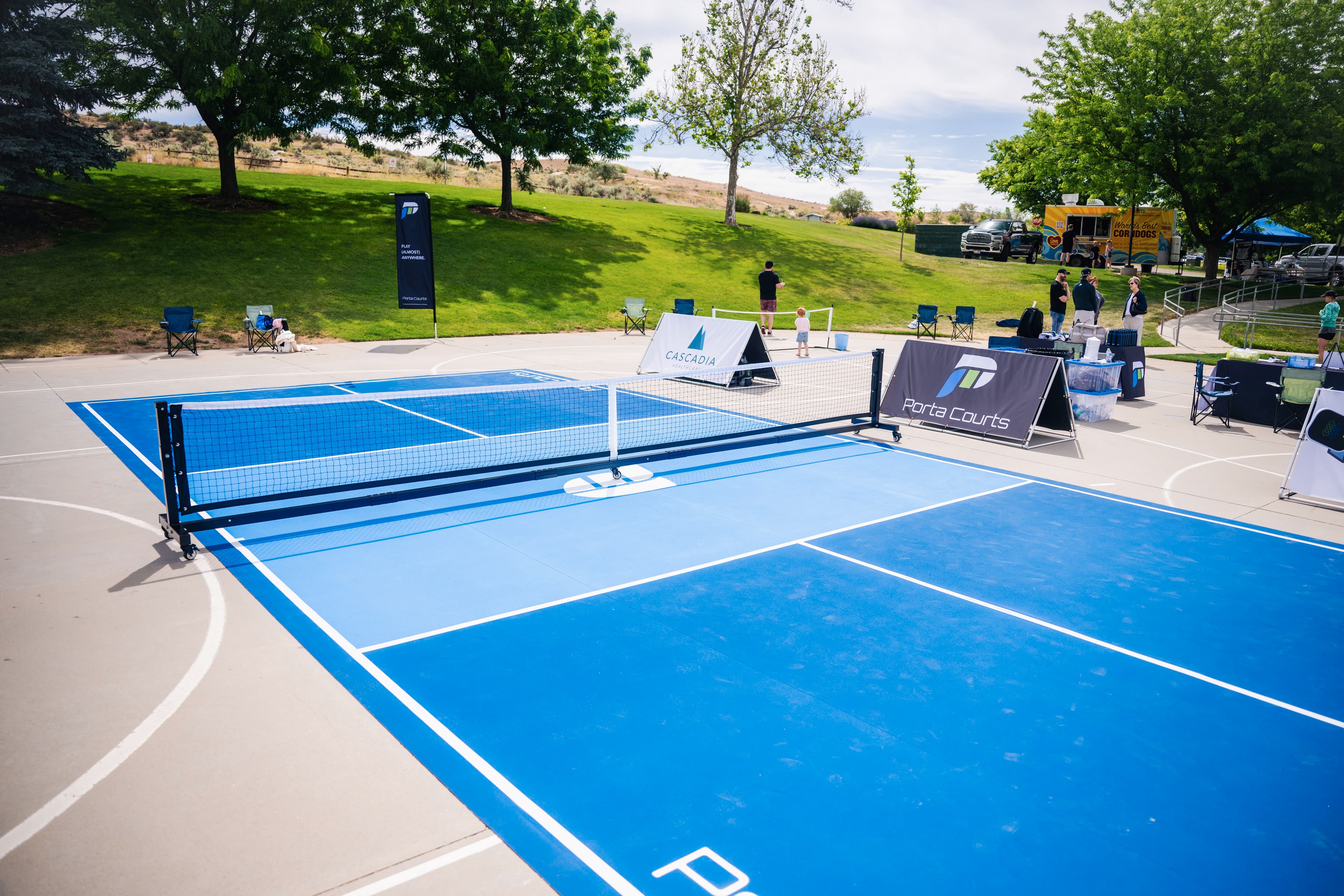 Blue PortaCourt setup with banners